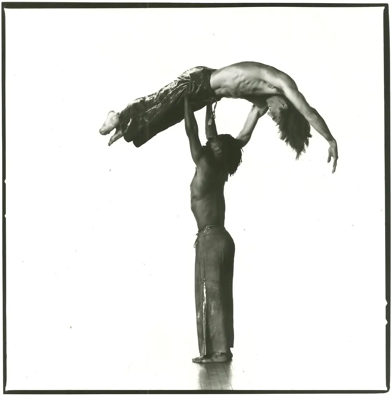 Two Bebe Miller Company dancers in an acrobatic lift