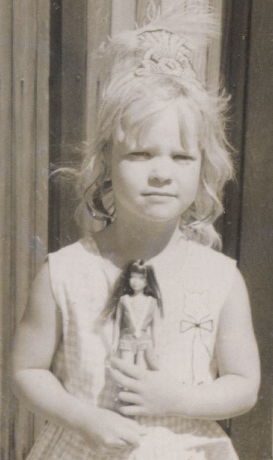 Katia Noyes as a child, holding a doll