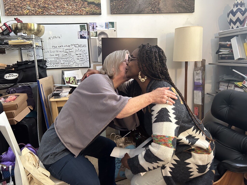 Katia Noyes and Courtney Desiree Morris embracing after the viewing