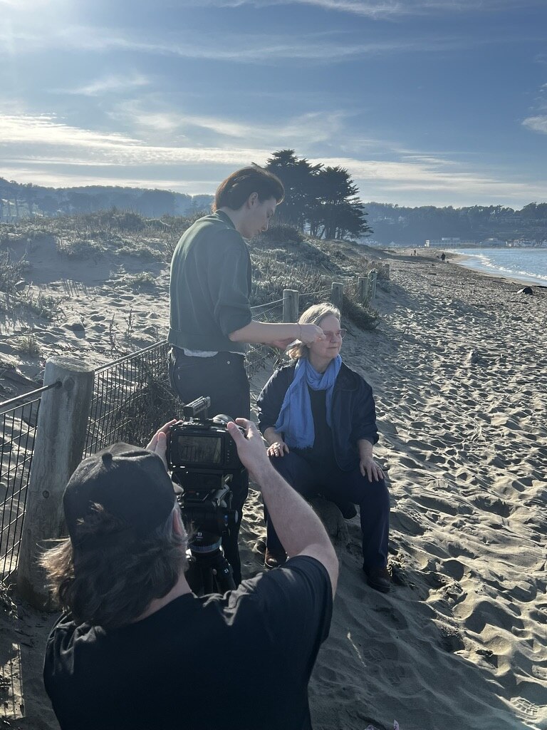 Katia Noyes being filmed by director Daniel Talbott on a San Francisco beach