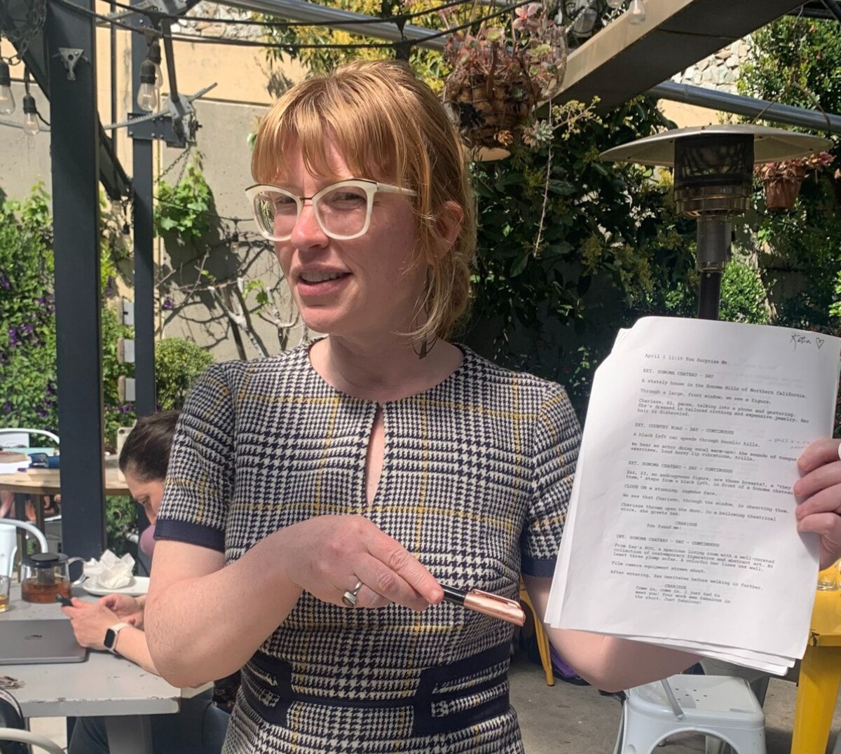 Madison Young holding pages of Katia Noyes’s screenplay