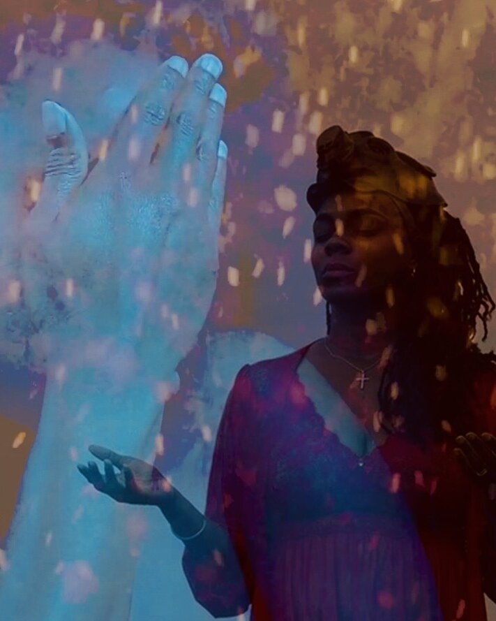 Courtney Desiree Morris layered with a large translucent blue hand and falling light