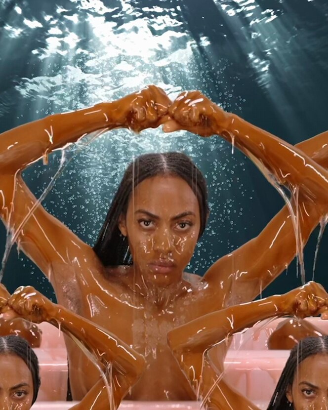 Courtney Desiree Morris emerging through water and layered arms
