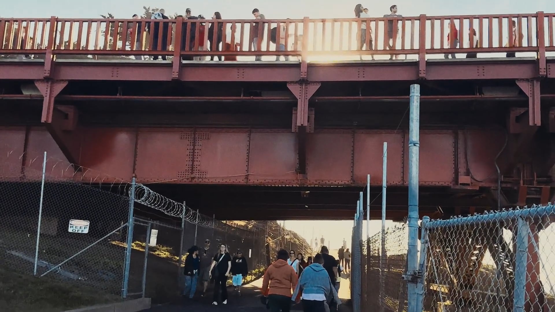 People walking above and below a San Francisco bridge in A View from Next Door